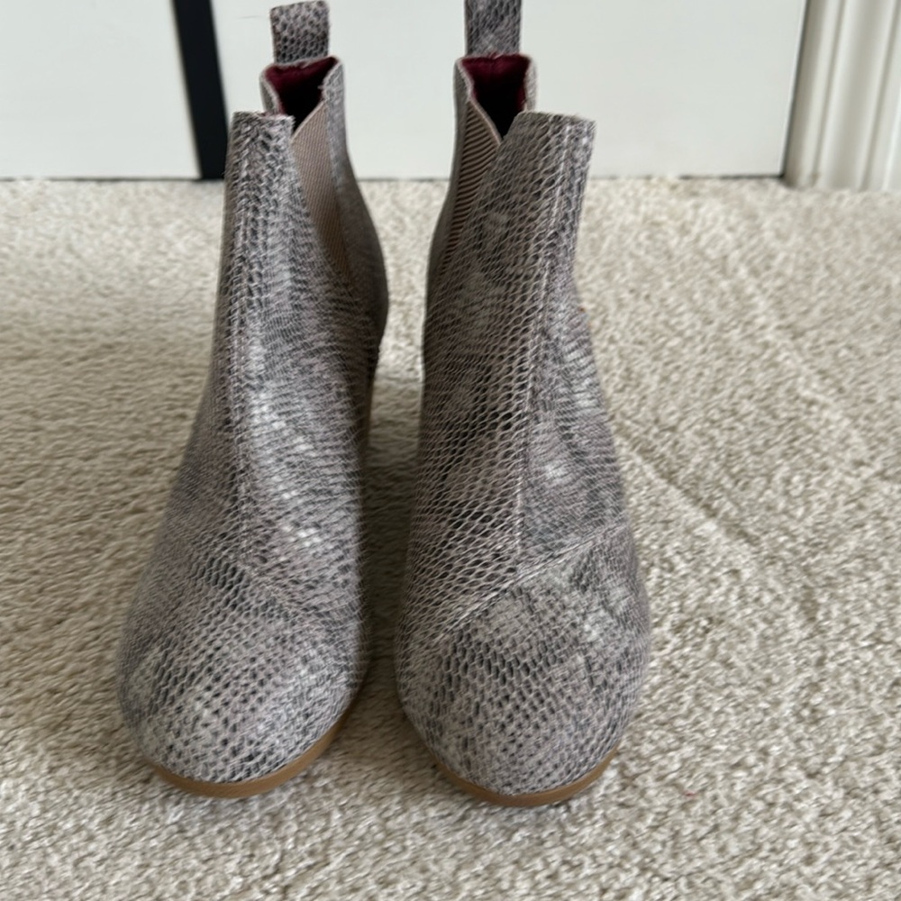 Tom’s snakeskin wedge booties